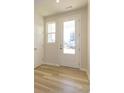 Bright entryway featuring wood-look flooring, white trim, and a glass-paneled front door for natural light at 8021 Lerwick Trl, Charlotte, NC 28269