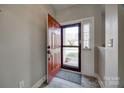 Welcoming entryway featuring a vibrant red front door with glass and a neutral interior at 10071 Highland Creek Cir, Indian Land, SC 29707
