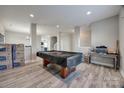 Large living room featuring a billiards table and grey wood flooring at 10071 Highland Creek Cir, Indian Land, SC 29707