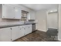 Bright kitchen with white cabinets, stainless steel appliances, subway tile backsplash, and granite countertops at 1024 Eaglewood Ave, Charlotte, NC 28212