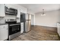 Modern kitchen featuring stainless steel appliances, granite countertops, and ample cabinet space for storage at 1024 Eaglewood Ave, Charlotte, NC 28212