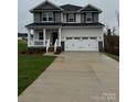 Charming two-story home featuring a welcoming front porch and a convenient two-car garage at 103 High Rock Ct # 11, Statesville, NC 28677