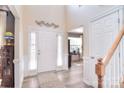 Bright foyer with high ceilings, white wainscoting, and elegant wood-look flooring at 1100 Millbank Dr, Matthews, NC 28104