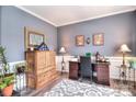 Cozy home office with stylish gray walls, crown molding, and wood-look floors at 1100 Millbank Dr, Matthews, NC 28104