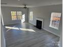 Bright living room with hardwood floors, a fireplace, and large windows offering ample natural light at 117 High Rock Ct # 9, Statesville, NC 28677