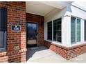 Inviting covered brick porch with a black front door and large window at 126 Adelaide Way, Rock Hill, SC 29732