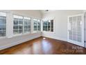 Bright sunroom featuring hardwood floors and large windows with a glass door at 126 Adelaide Way, Rock Hill, SC 29732