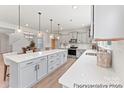 Modern kitchen features gray cabinets, stainless steel appliances, pendant lighting, and a large island at 2308 Bulwarks Ct # 8P, Albemarle, NC 28001