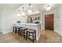 Contemporary kitchen with light gray cabinetry, stainless steel appliances, a breakfast bar, and hardwood floors at 300 W 5Th St # 344, Charlotte, NC 28202