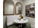 Bright breakfast nook featuring a marble table, modern mirrors, art, and stylish decor at 3063 Finchborough Ct # 216, Charlotte, NC 28269