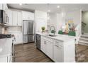 Bright kitchen with stainless steel appliances, a stylish island, and elegant pendant lighting at 3063 Finchborough Ct # 216, Charlotte, NC 28269