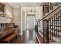 Welcoming foyer with hardwood floors, a grand staircase, and elegant chandelier at 4006 Sincerity Rd, Monroe, NC 28110