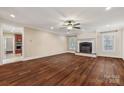 Spacious living room featuring hardwood floors, a fireplace, and a ceiling fan at 4006 Sincerity Rd, Monroe, NC 28110