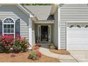Close-up of the front entrance with vibrant flowers, house number, and covered entryway at 4323 Wiregrass Rd, Indian Land, SC 29707