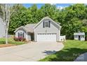 Charming home with a two-car garage, complemented by lush landscaping and a cozy shed at 4323 Wiregrass Rd, Indian Land, SC 29707