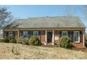 Charming brick home featuring blue shutters and a well-manicured lawn at 4626 Annerly Ct, Charlotte, NC 28226