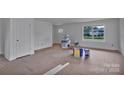 Bright, unfinished living room with a large window showcasing the yard view at 515 Harrel St, Salisbury, NC 28144