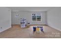 Spacious unfinished living room with natural light from the large window at 515 Harrel St, Salisbury, NC 28144