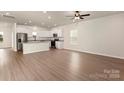 Bright and airy living space featuring hardwood floors and seamlessly connecting to an open-concept kitchen with modern appliances at 5614 Skinny Dr, Charlotte, NC 28215