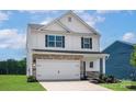 Two-story home featuring stone accents, white siding, a two-car garage and black shutters at 5704 Skinny Dr, Charlotte, NC 28215