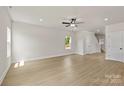Open concept living area with hardwood floors, natural light, neutral walls, and a ceiling fan at 5704 Skinny Dr, Charlotte, NC 28215