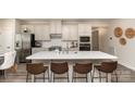 Modern kitchen boasts a large center island with seating, stainless steel appliances, and sleek countertops at 6419 Cambridge Dr, Harrisburg, NC 28075