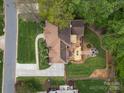 A beautiful backyard featuring an outdoor deck area with furniture and a stone firepit perfect for entertaining at 9009 Stourbridge Dr, Huntersville, NC 28078