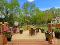Relaxing back deck with comfortable seating and beautiful flower arrangements, overlooking a lush green yard at 9009 Stourbridge Dr, Huntersville, NC 28078