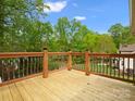 Spacious deck with wooden railing and lush green backyard view at 9009 Stourbridge Dr, Huntersville, NC 28078