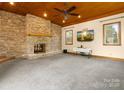Spacious living room with a stone fireplace and windows that provide ample natural light at 9009 Stourbridge Dr, Huntersville, NC 28078