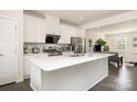 Modern kitchen with white cabinetry, stainless steel appliances, and a spacious center island at 108 Helm Ln, Mooresville, NC 28117