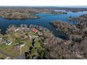 Aerial view of a lakeside community featuring mature trees, manicured lawns, and stunning lake views at 108 N Oakwood Dr, Kings Mountain, NC 28086