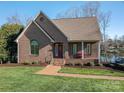 Beautiful brick home with manicured lawn, brick walkway, and lovely front porch at 108 N Oakwood Dr, Kings Mountain, NC 28086