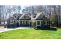 Beautiful home featuring stone accents, a well-manicured lawn, and an attached garage at 147 Pearl Bay Dr, New London, NC 28127