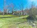 Modest single-Gathering house with a stone foundation and open front yard with mature trees at 2033 Shelby Rd, Kings Mountain, NC 28086