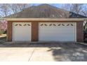 Attached two car garage and extra one car garage featuring white doors at 2430 Berkshire Dr, Salisbury, NC 28146