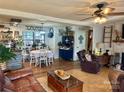 Inviting living room featuring warm wood floors, shiplap walls, and a cozy brick fireplace at 25924 Millingport Rd, Albemarle, NC 28001