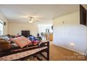 Open-concept living area with a TV, ceiling fan, and a view into the kitchen at 340 W Memorial Hwy, Harmony, NC 28634