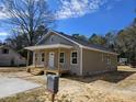 Well-lit single story home with white trim, a white door, and a covered porch ready for personalization at 406 White Store Rd, Wadesboro, NC 28170