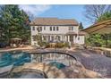 Resort-style backyard featuring a luxurious pool, pergola, lounge chairs, and a cozy fire pit at 4536 Rustling Woods Dr, Denver, NC 28037