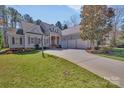 Charming traditional-style home with an inviting entryway, three-car garage and a well-manicured front yard at 4536 Rustling Woods Dr, Denver, NC 28037