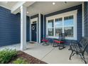 Inviting front porch featuring seating, a welcoming wreath, and classic design elements at 456 Lucky Dr, Concord, NC 28027