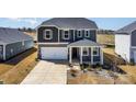 Two-story home with a covered front porch, a stone foundation, and a two-car garage at 5013 Dunsford Dr, Denver, NC 28037