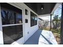 This home's front porch boasts a screened door, modern exterior lighting, and neutral paint at 621 Cauthen St, Rock Hill, SC 29730