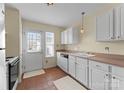 Functional kitchen with white cabinetry, essential appliances, and a doorway leading to the outdoors, perfect for cooking at 6635 Vlosi Dr, Charlotte, NC 28226