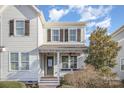 Charming two-story home featuring a welcoming front porch and a neatly maintained lawn at 758 Waterscape Ct, Rock Hill, SC 29730