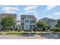 Charming two-story home featuring a light blue exterior, black shutters, and a well-manicured front yard at 758 Waterscape Ct, Rock Hill, SC 29730