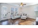 Bright living room with hardwood floors, comfortable seating, and natural light streaming through the windows at 758 Waterscape Ct, Rock Hill, SC 29730