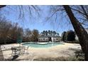 Community pool featuring ample lounge chairs and tables, perfect for relaxation and socializing at 9130 Charminster Ct, Charlotte, NC 28269