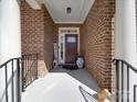 Inviting brick front porch with a Welcome sign, blue vase, and overhead light at 9786 Verdun Ct, Fort Mill, SC 29707